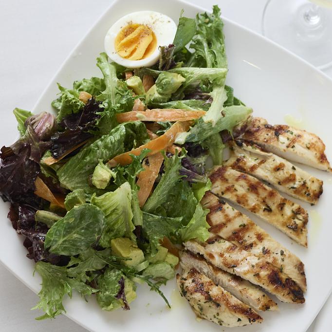 Product: Grilled chicken, hard boiled egg, toasted pepita seeds, avocado, carrots, mixed green salad, lemony caesar dressing - Angelino Restaurant in Sausalito, CA Italian Restaurants