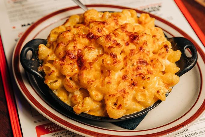 Product: Black skillet bowl filled with oven-baked macaroni and cheese - Bub City in Rosemont, IL Barbecue Restaurants