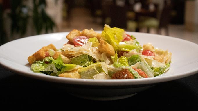 Product: romaine, asiago cheese, roasted local heirloom cherry tomatoes, herbed croutons - Coastal Kitchen and Bar in Uptown - Charlotte, NC American Restaurants