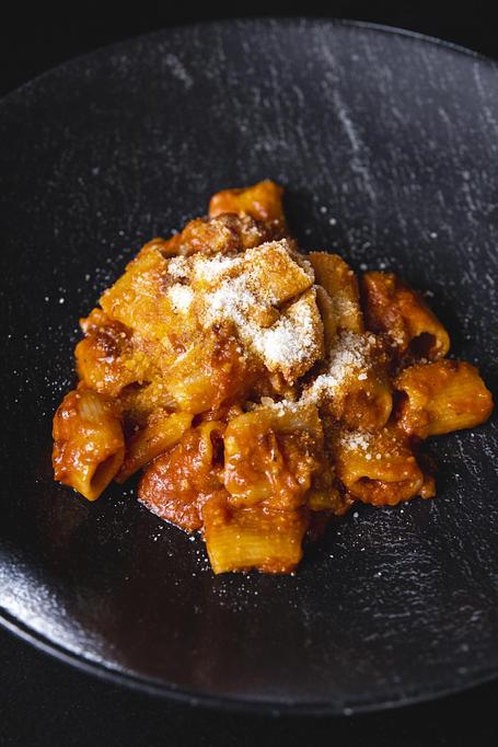 Product: Amatriciana - Bigoli Pasta & Crispy Cured Pork Jowl, Cooked into a Slightly Spicy Tomato Sauce with Pecorino Romano Cheese. Very Flavorful, Rich Pork & Tomato Flavor. - Bello by Sandro Nardone in Newport Beach, CA Bars & Grills
