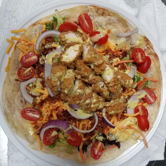 Product: Mixed greens with cheddar cheese, bacon, red onions, pear tomatoes, tossed with our honey mustard dressing and topped with crispy chicken. - Black Rock Bar & Grill in Orlando, FL American Restaurants