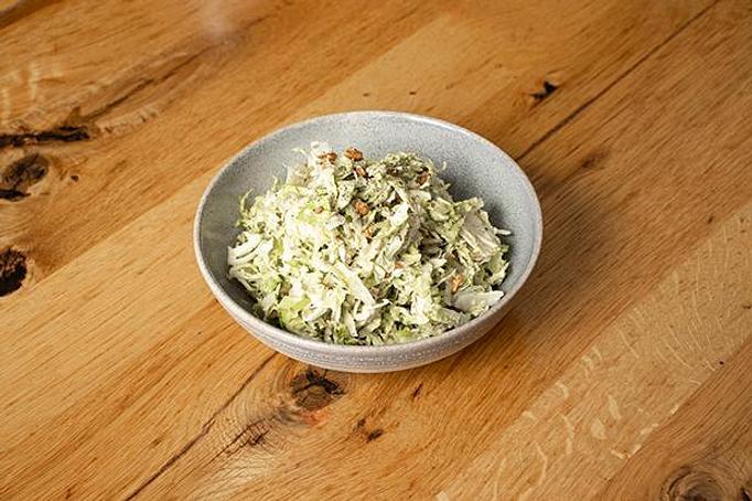 Product: Three green shredded Brussels sprouts in a grey bowl on a wooden surface - Cafe Ba-Ba-Reeba! in Lincoln Park - Chicago, IL Gluten Free Restaurants