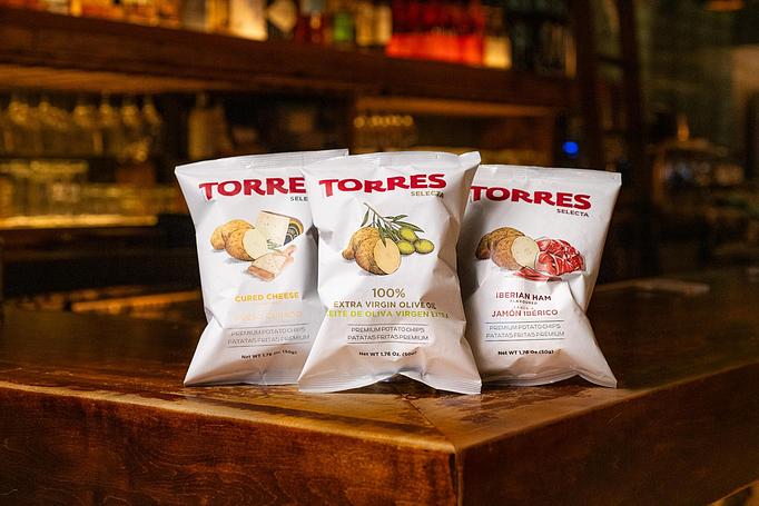 Product: Three white bags of potato chips labeled with the word TORRE in bold red font, with illustrations of cheese, potatoes, and ham on each. - Cafe Ba-Ba-Reeba! in Lincoln Park - Chicago, IL Gluten Free Restaurants