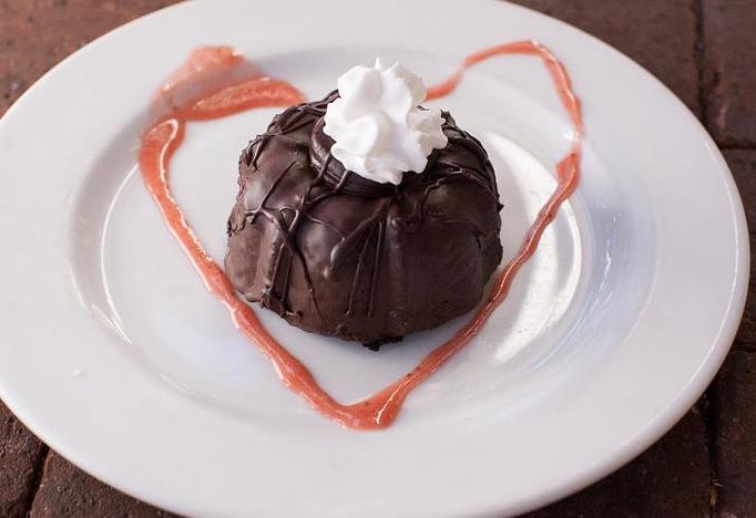 Product: Rich yummy dark chocolate cake with shaved chocolate on top. - Chase Restaurant in Santa Barbara, CA American Restaurants
