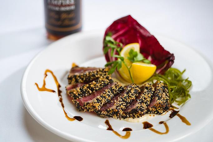 Product: fresh high-quality tuna covered in sesame seeds, lightly seared and served with our signature sauce. - Empire Steak House in New York, NY Seafood Restaurants