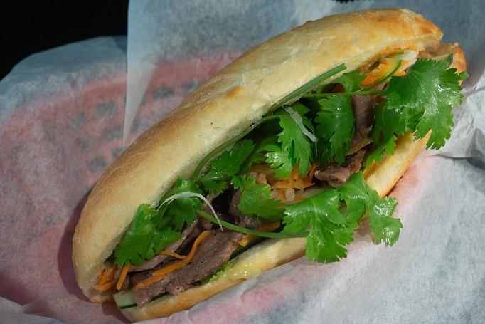Product: Sliced charbroiled pork with cucumber, cilantro, jalapeno pepper, and pickled carrot in a demi baguette - Eurasian Bistro in Argonaut Village - Pensacola, FL Vietnamese Restaurants