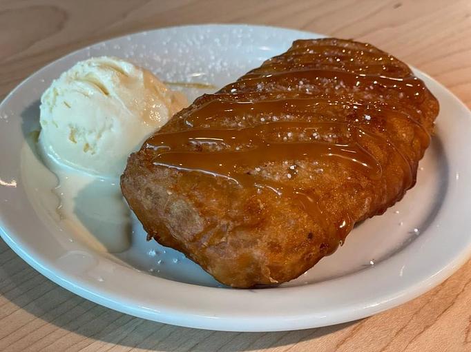 Product: Crispy fried banana sprinkled with powder sugar and lightly drizzled with caramel served with a scoop of ice cream (dine in) - Eurasian Bistro in Argonaut Village - Pensacola, FL Vietnamese Restaurants