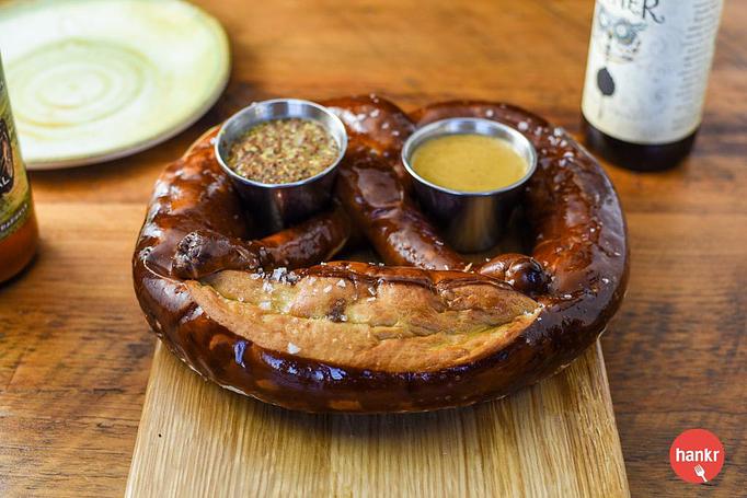 Product: Clasen’s pretzel, Maldon sea salt, clarified butter with choice of beer mustard or beer cheese sauce - Longtable Beer Cafe in Downtown Middleton - Middleton, WI American Restaurants