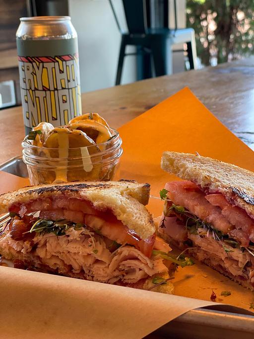 Product: Nueske’s smoked turkey breast, crispy prosciutto, house-made apple butter, tomato, mixed greens on MSDC sourdough - Longtable Beer Cafe in Downtown Middleton - Middleton, WI American Restaurants