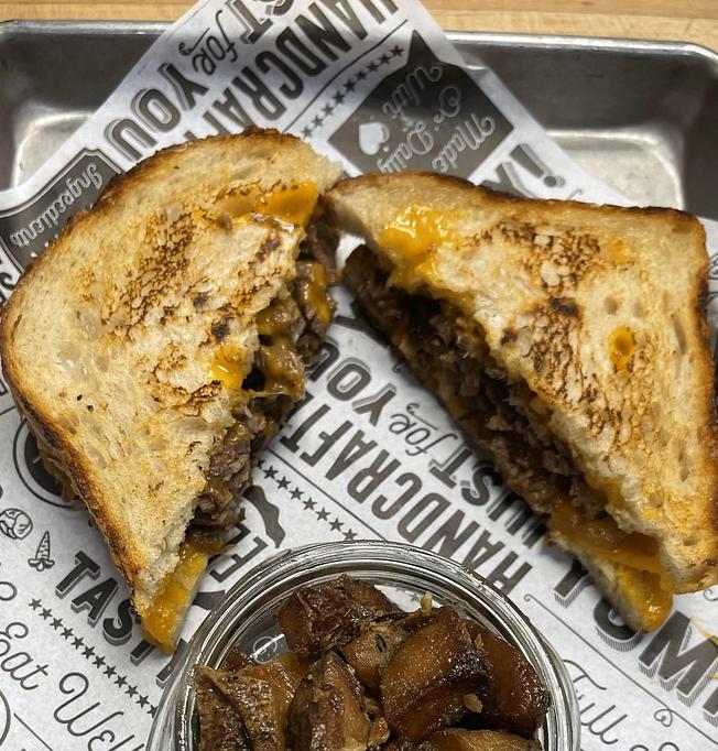 Product: House smoked brisket, Hook’s 1 year cheddar, caramelized onion on MSDC sourdough - Longtable Beer Cafe in Downtown Middleton - Middleton, WI American Restaurants