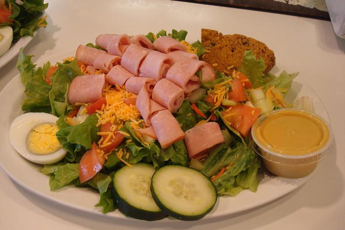 Product: Turkey or Ham, Leaf Lettuce, Mushrooms, Carrots, Celery, Half Hard-Boiled Egg, Tomato, Red Cabbage, Onion, and Cheese, served with homemade Apple or Pumpkin Bread. - Nutshell Eatery & Bakery in Granbury, TX American Restaurants