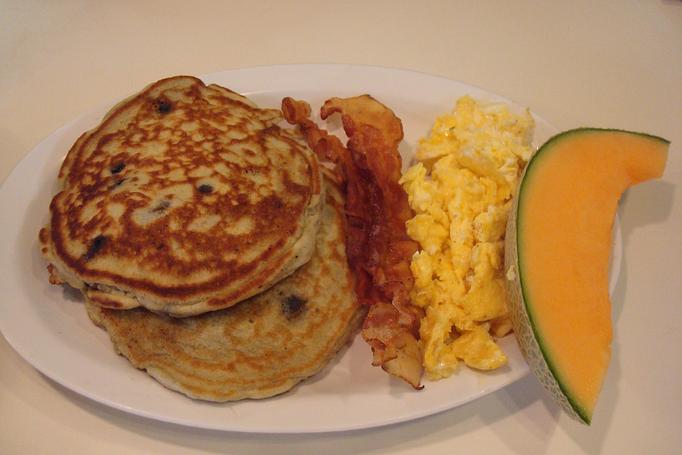 Product: 2 eggs any style, bacon, and whole made blue berry pancakes with fresh fruit - Nutshell Eatery & Bakery in Granbury, TX American Restaurants