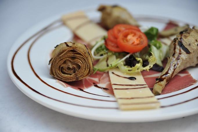 Product: Thin sliced prosciutto served with lightly grilled imported long stem artichokes with parmesan cheese and a pettit salad - Pasta D'arte Trattoria Italiana in Chicago, IL Italian Restaurants