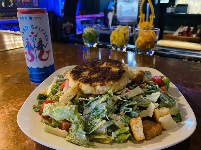 Product: Caeser Salad with crabcake topping, smoked chicken also available - Phoebus Dive Bar in Hampton, VA Bars & Grills