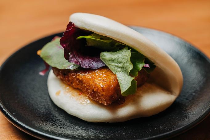 Product: marinated tofu breaded and fried, tossed in a sweet and spicy thai sauce, and served on a steamed bun with mixed greens - RAMEN-SAN Whisky Bar in Fulton Market - Chicago, IL Japanese Restaurants