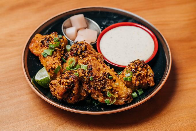 Product: five crispy chicken wings are tossed in a housemade spicy sesame chili sauce. served with fried garlic, pickled japanese daikon radish and lime kosho mayo - RAMEN-SAN Whisky Bar in Fulton Market - Chicago, IL Japanese Restaurants