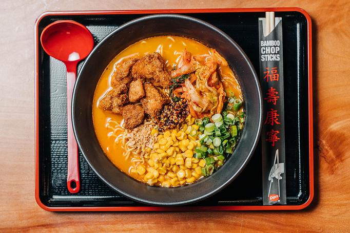 Product: a crunchy and spicy ramen with pork broth, tokyo wavy noodles, green onion, spicy kimchi, karaage fried chicken, buttered corn, fried garlic and housemade sesame chili oil - RAMEN-SAN Whisky Bar in Fulton Market - Chicago, IL Japanese Restaurants