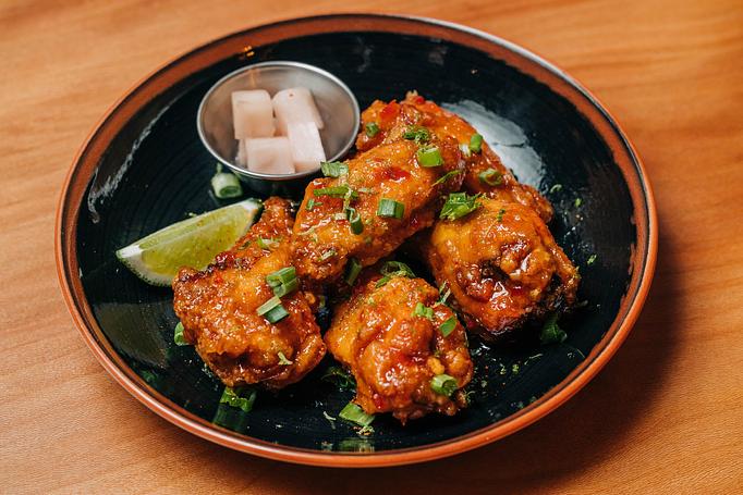 Product: five crispy chicken wings are tossed in a housemade sweet chili sauce. served with pickled japanese daikon radish and lime - RAMEN-SAN Whisky Bar in Fulton Market - Chicago, IL Japanese Restaurants