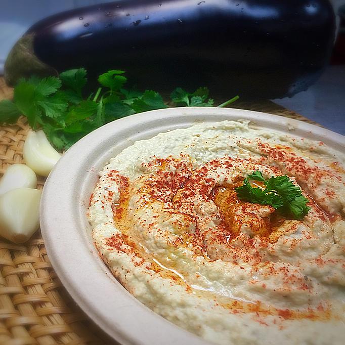 Product: Eight oz cup charbroiled eggplants with tahini, Lemon juice, garlic and olive oil, served with two pitas - Rosemary Grill in Los Angeles, CA Mediterranean Restaurants