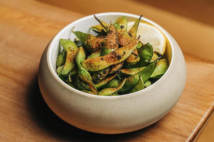 Product: whole edamame pods are tossed in garlic oil and roasted in our coal-burning oven before being finished with a squeeze of lemon and a dusting of our signature S+P seasoning - Sushi San - Reservations in River North - Chicago, IL Japanese Restaurants