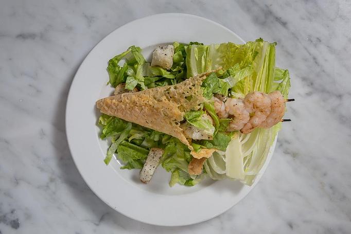 Product: Romaine lettuce with house-made Caesar dressing & garlic croutons in a Parmesan cheese waffle cone. Great on-the-go meal.   Tempt Restaurant - New Orleans French Quarter - Tempt in French Quarter / CBD - New Orleans, LA American Restaurants