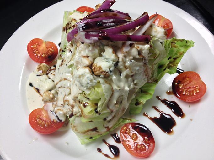 Product: Classic Wedge Salad with Balsamic Reduction,  Bleu Cheese Crumbles, Bleu Cheese Dressing and Sliced Red Onion - The Caboose Restaurant in Located in Beautiful Downtown McComb - McComb, MS Cajun & Creole Restaurant