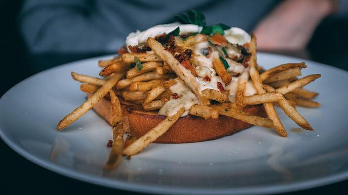 Product: smashed avocado, turkey sausage, french fries, pico, sour cream on rye toast [with added egg $2] - The Pressed Penny Tavern in Kansas City, MO American Restaurants