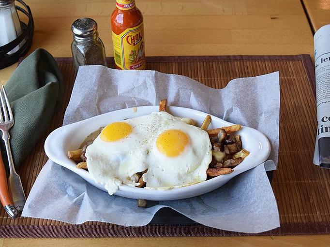 Product: Breakfast Poutine - Fries, cheese curds, sausage, and beef gravy topped with two eggs your way - West Allis Cheese & Sausage Shoppe in West Allis, WI Coffee, Espresso & Tea House Restaurants