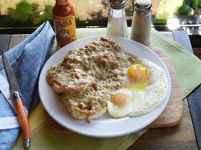 Product: Biscuits and Gravy - two biscuits smothered in sausage gravy and served with two eggs your way - West Allis Cheese & Sausage Shoppe in Milwaukee, WI Meat Products