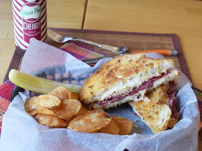 Product: Reuben - corned beef, sauerkraut, swiss, homemade 1,000 island, grilled on rye - West Allis Cheese & Sausage Shoppe in Milwaukee, WI Meat Products