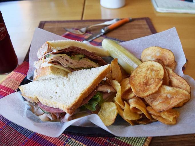 Product: Stallis Stack - ham, turkey, salami, bacon, provolone, goat chevre, cucumber, lettuce, honey mustard, on sourdough bread - West Allis Cheese & Sausage Shoppe in Milwaukee, WI Meat Products