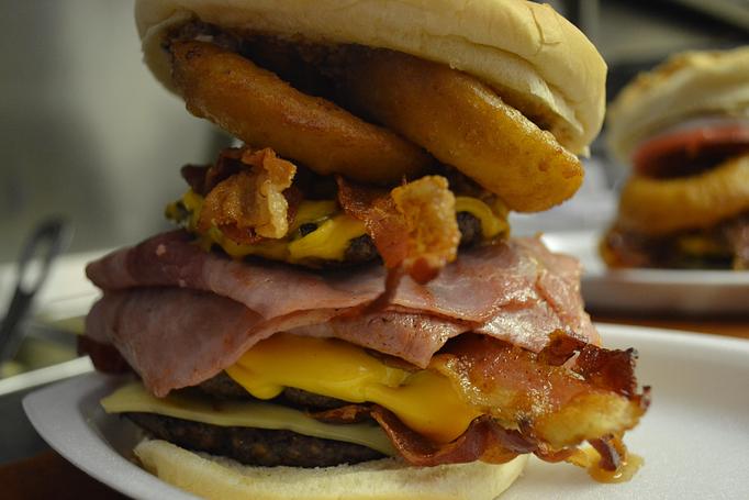 Product: A triple Cheeseburger is the foundation, then we add Ham, Bacon, Swiss and American Cheeses, two Beer-Battered Onion Rings, and top it all off with a scoop of our homemade Chili!  Come hungry! - Bob's Dairyland in Roan Mountain, TN American Restaurants