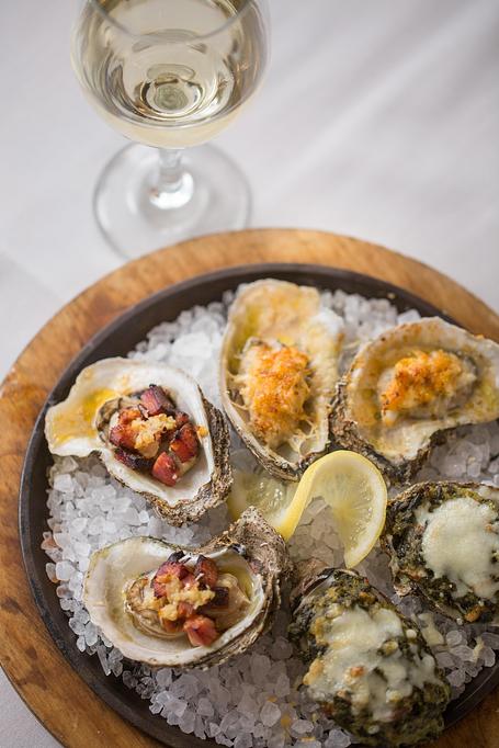 Product: Trio platter of delicious fresh shucked Gulf oysters baked to perfection. - Eugene's Gulf Coast Cuisine in Houston, TX Seafood Restaurants