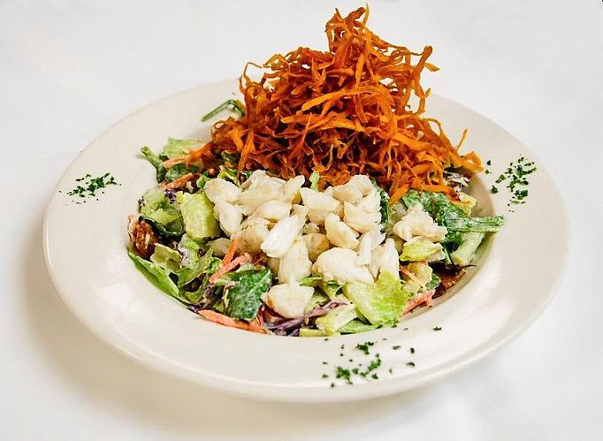 Product: Romaine & baby spinach tossed with garlic Remoulade. Topped with bacon, diced tomatoes, jumbo lump crabmeat & fried sweet potato strings - Eugene's Gulf Coast Cuisine in Houston, TX Seafood Restaurants