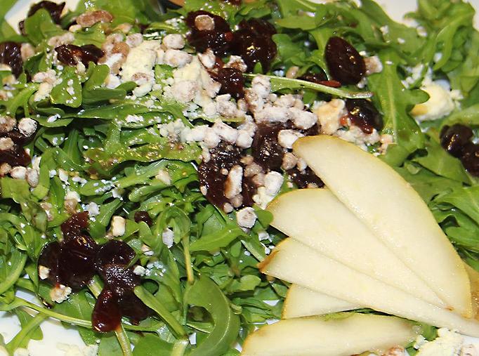 Product: Pears, organic arugula, candied pecans, stout cranberries and crumbled bleu cheese with balsamic vinaigrette. - Foothills Brewing in Winston Salem, NC American Restaurants