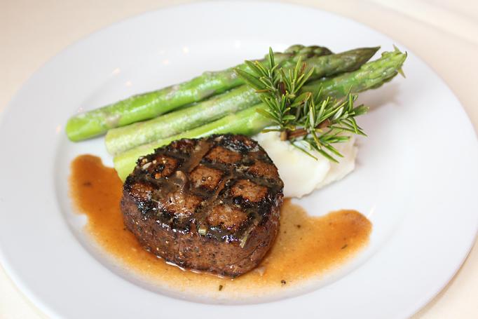 Product: 8 oz. filet rubbed with porcini mushroom, grilled and served with roasted garlic mashed potatoes, asparagus and veal demi-glace. - JJ's Restaurant in Kansas City, MO French Restaurants