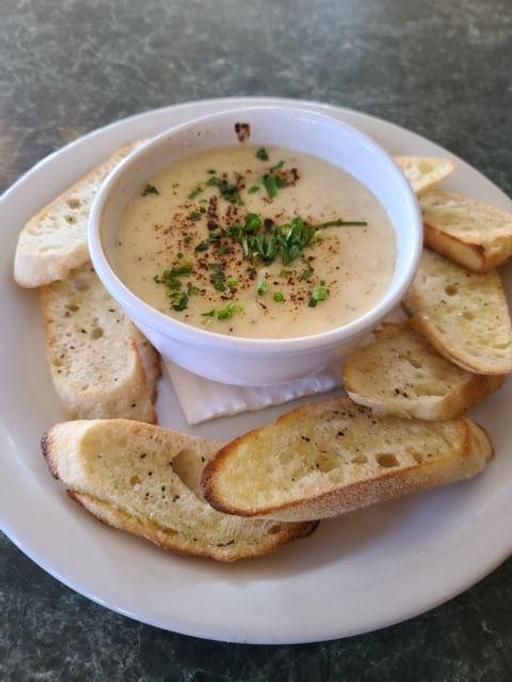 Product: Oven baked fondue of Mozzarella, Parmesan, poached garlic and crostini slices. - Kelso Theater Pub and Backstage Cafe in Downtown Kelso Wa. - Kelso, WA American Restaurants