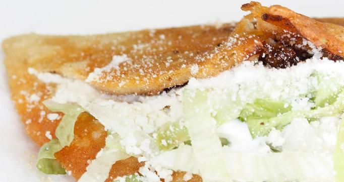 Product: Folded, pan-fried Corn Tortilla of handmade dough with your choice of filling, Lettuce, Cotija Cheese & Sour Cream. - La Lupita Tacos Mexicanos in Olneyville - Providence, RI Mexican Restaurants