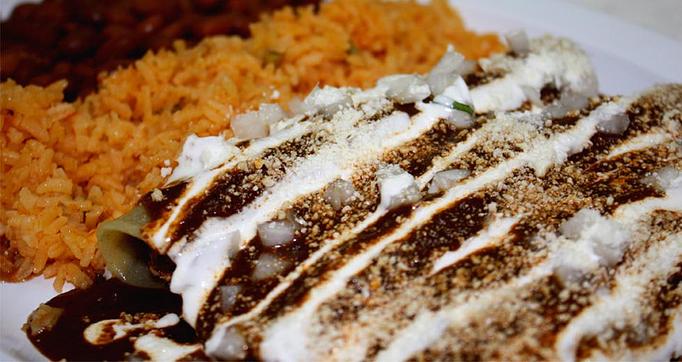 Product: (3) Rolled Corn Tortillas stuffed with your choice of meat and doused in an authentic Mole made of a closely guarded Old World combination of Dried Peppers & Spices, served with (2) Sides - La Lupita Tacos Mexicanos in Olneyville - Providence, RI Mexican Restaurants