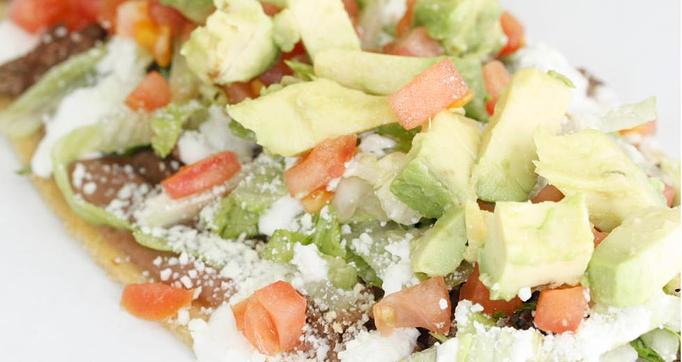 Product: Steak Huarache (Supreme) A handmade oval shaped Corn Tortilla smothered with Refried Beans and topped with Meat, Onion, Cilantro, Lettuce, Cotija Cheese, Sour Cream & Avocado. - La Lupita Tacos Mexicanos in Olneyville - Providence, RI Mexican Restaurants