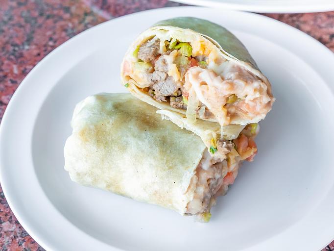 Product: Soft Flour Tortilla packed with Meat, Yellow Rice, Refried or Whole Beans, Onion, Cilantro, Lettuce, Tomato, Mozzarella Cheese & Sour Cream - La Lupita Tacos Mexicanos in Olneyville - Providence, RI Mexican Restaurants