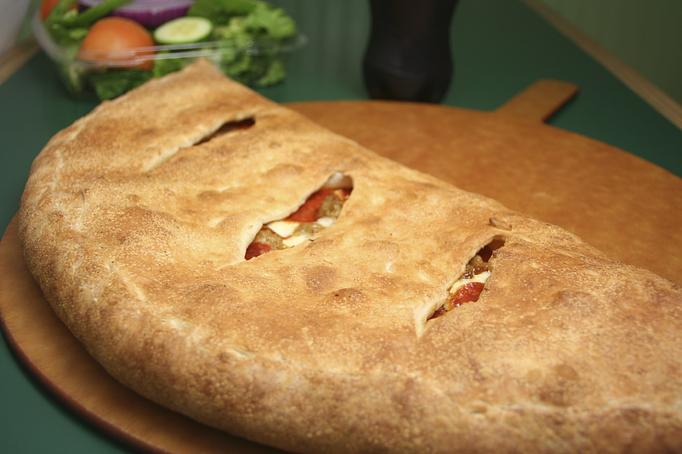 Product: Try a calzone with your favorite toppings! - Moosejaw Pizza in The Waterpark Capital of the World in Wisconsin Dells! - Wisconsin Dells, WI American Restaurants