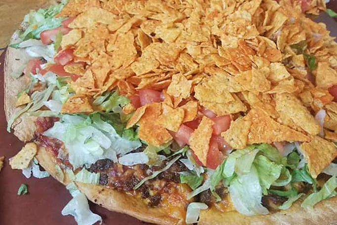 Product: Topped with lettuce, diced tomatoes & taco chips - Moosejaw Pizza in The Waterpark Capital of the World in Wisconsin Dells! - Wisconsin Dells, WI American Restaurants