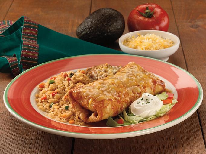 Product: A giant tortilla stuffed with your choice of meat or seafood filling, crisped until golden brown. Smothered in our special homemade sauce. Served with shredded lettuce, freshly chopped tomatoes, sour cream topping, Spanish rice and your choice of beans. - Paradiso Mexican Restaurant in Bismarck, ND Mexican Restaurants