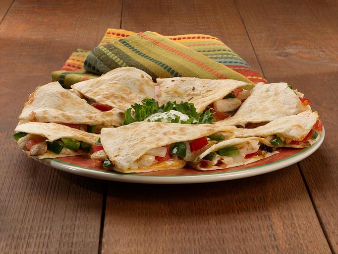 Product: Wow! A large flour tortilla fully stuffed with grilled chicken, bacon, mushrooms, fresh poblano peppers and mild Cheddar and Monterey Jack cheese. Grilled the Paradiso way and served with sour cream topping. - Paradiso Mexican Restaurant in Fargo, ND Mexican Restaurants