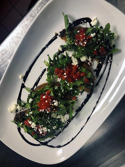 Product: Red pepper relish, tomato jam, goat cheese, arugula, sherry vinaigrette, and balsamic reduction. - Phoenix City Grille in Madison - Phoenix, AZ American Restaurants