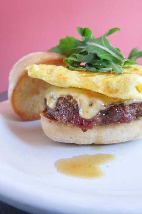 Product: house made ginger-sage sausage, local butterkase, cranberry pepper jelly, arugula & an over easy egg on our english muffin with a side of red potato mash - Southport Grocery & Cafe in Lakeview - Chicago, IL American Restaurants