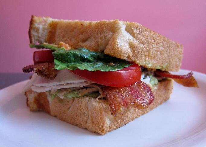 Product: turkey, bacon, romaine, tomato, shaved red onion & chipotle aioli on grilled challah bread with a dill pickle - Southport Grocery & Cafe in Lakeview - Chicago, IL American Restaurants