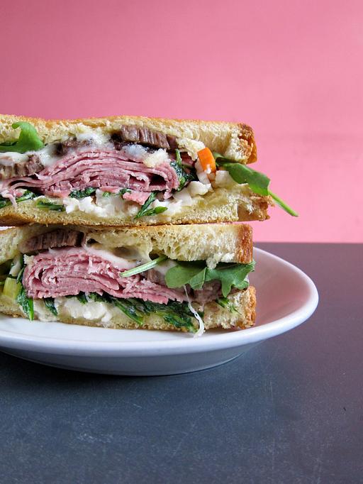 Product: smoked brisket, jake’s country meats ham, saxony gruyère, dijonnaise, jake's giard & arugula on grilled house made dutch crunch bread with a dill pickle - Southport Grocery & Cafe in Lakeview - Chicago, IL American Restaurants