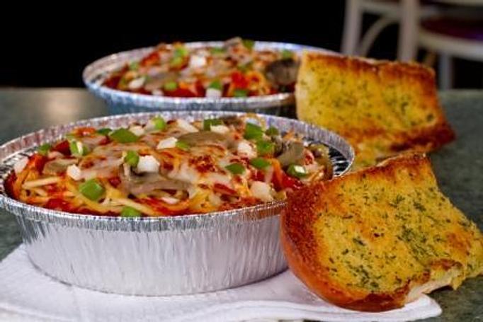 Product: Baked Spaghetti with Garlic Bread - The Spaghetti Junction in New Albany, IN Italian Restaurants